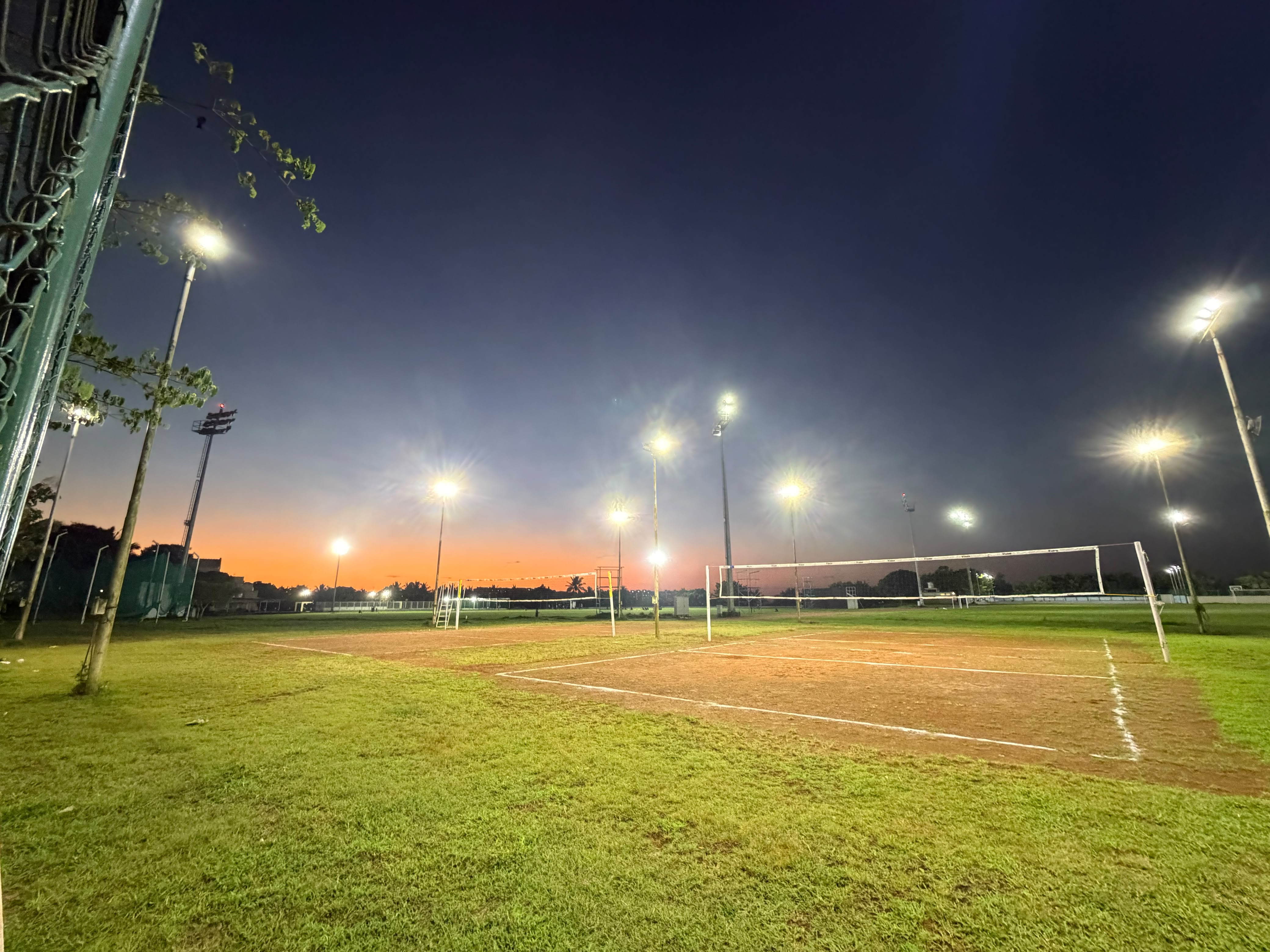 Sports Grounds under Floodlights at Dusk
